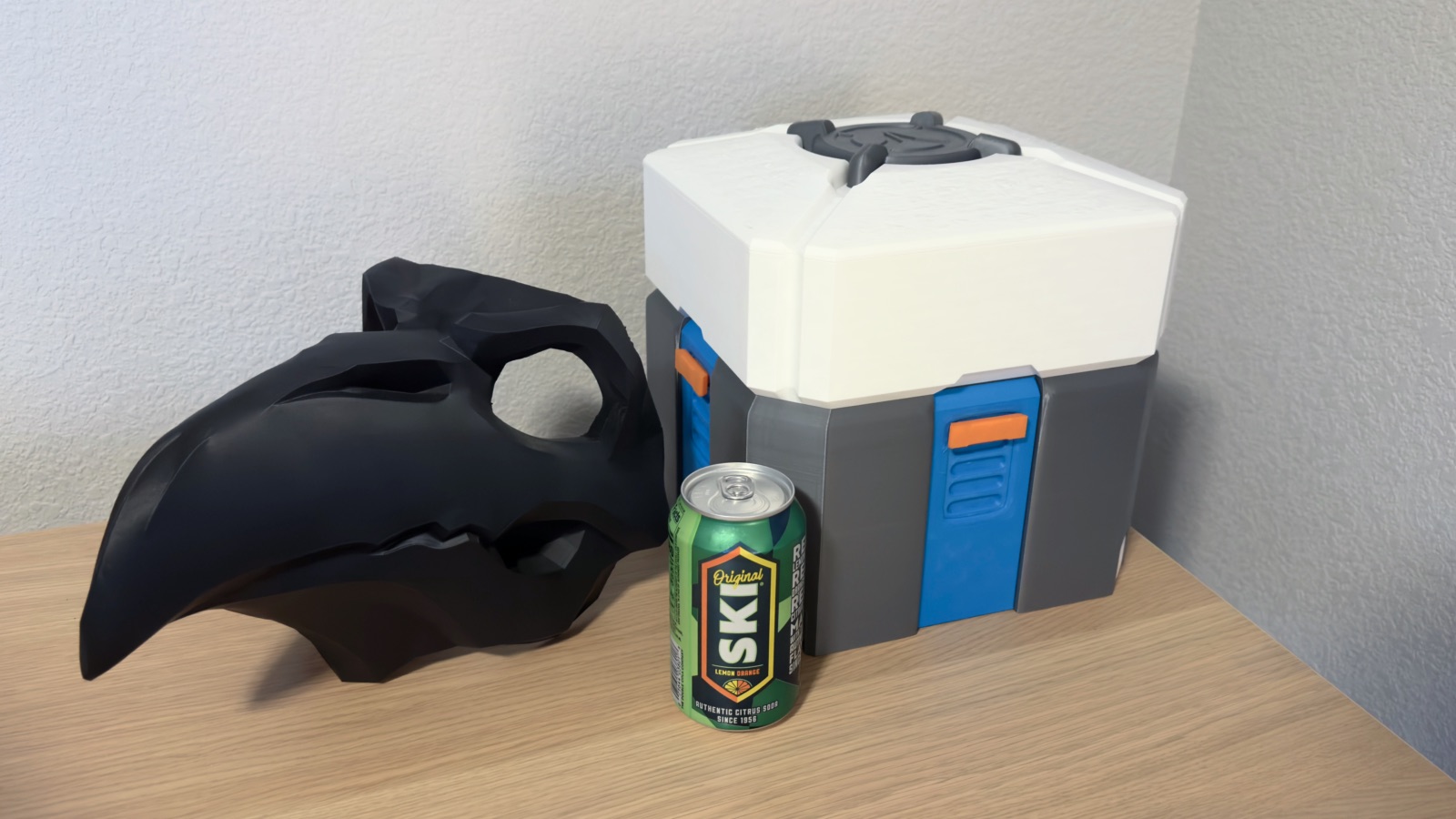 Overwatch Reaper Nevermore mask and loot box with a soda for scale