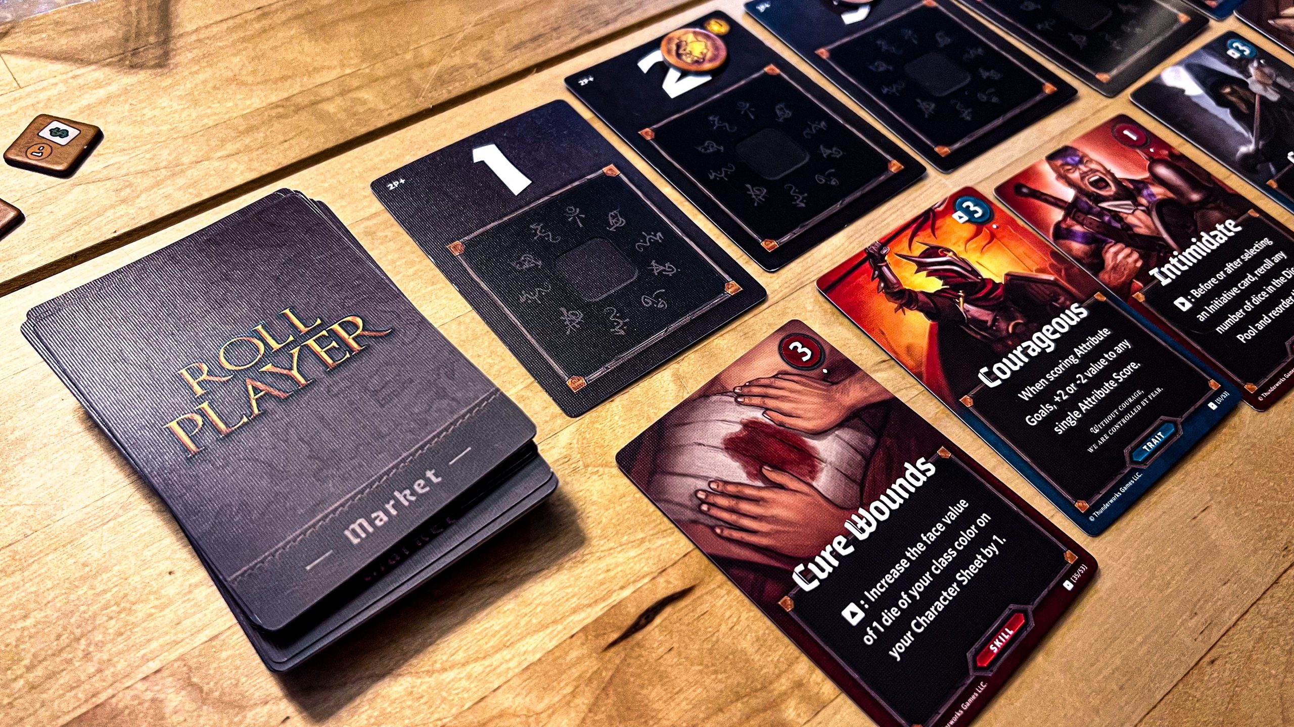 A photo showing the art from cards for the game Roll Player