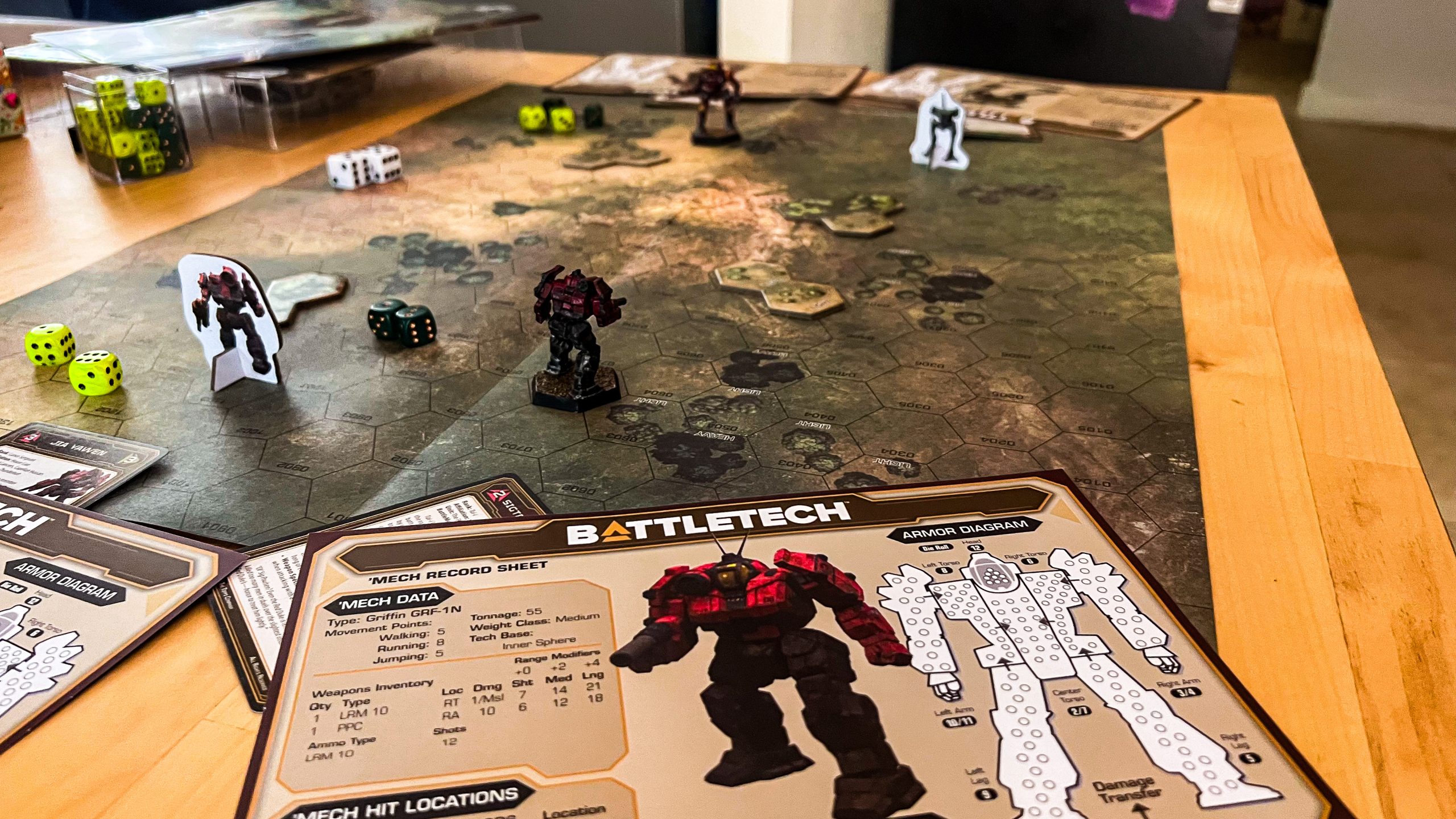 A game of battletech being played on a table