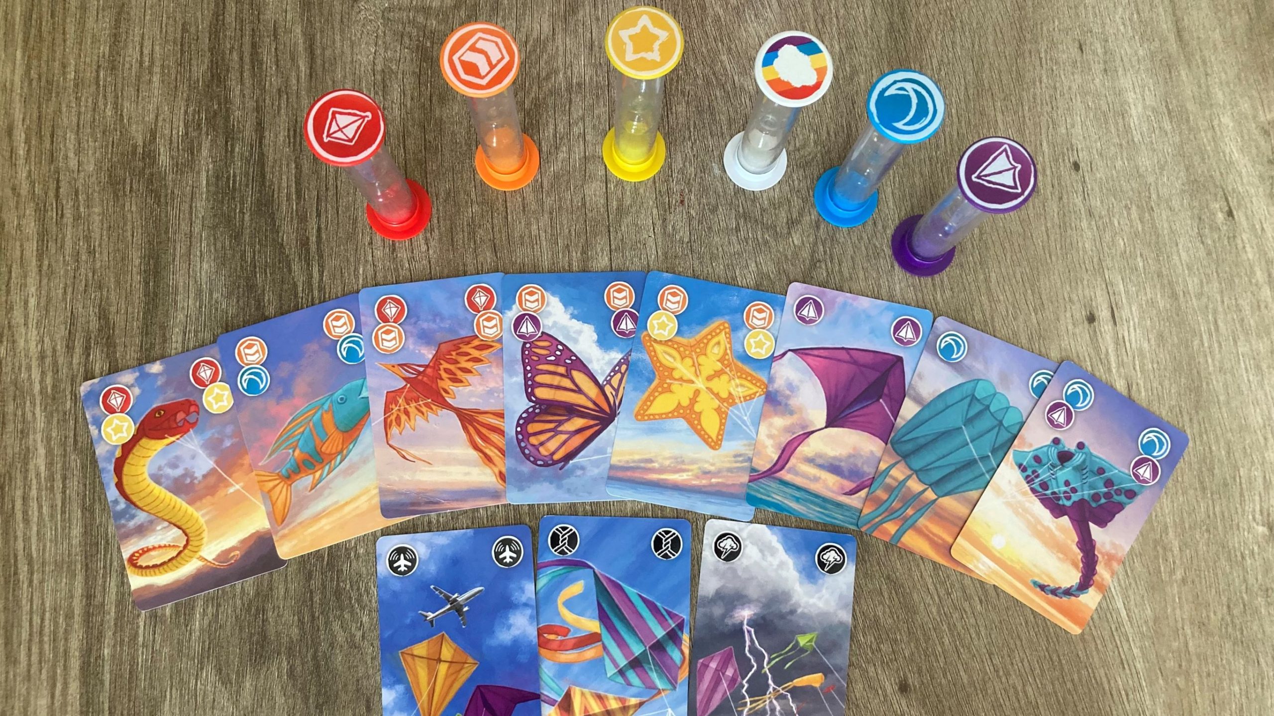 Cards from the game Kites below the colored sand timers