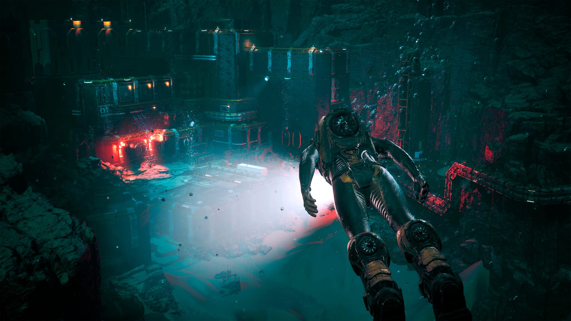 A person swimming in the under water city. Pipes are on the right. Buildings are in front of the person and we can see some lights on.