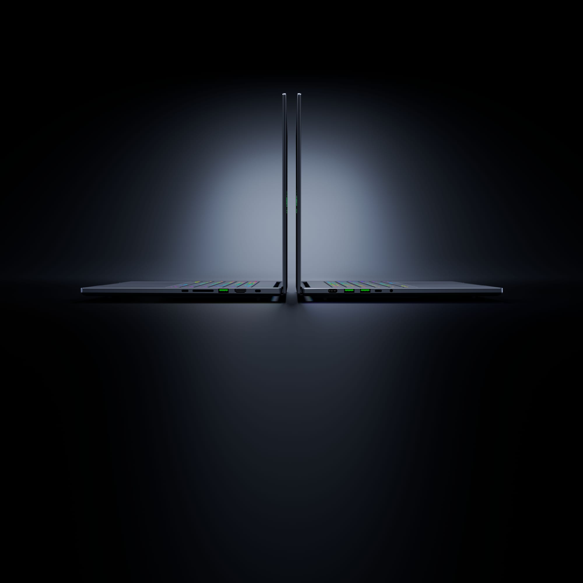 Two Razer Blade 16s from the side.