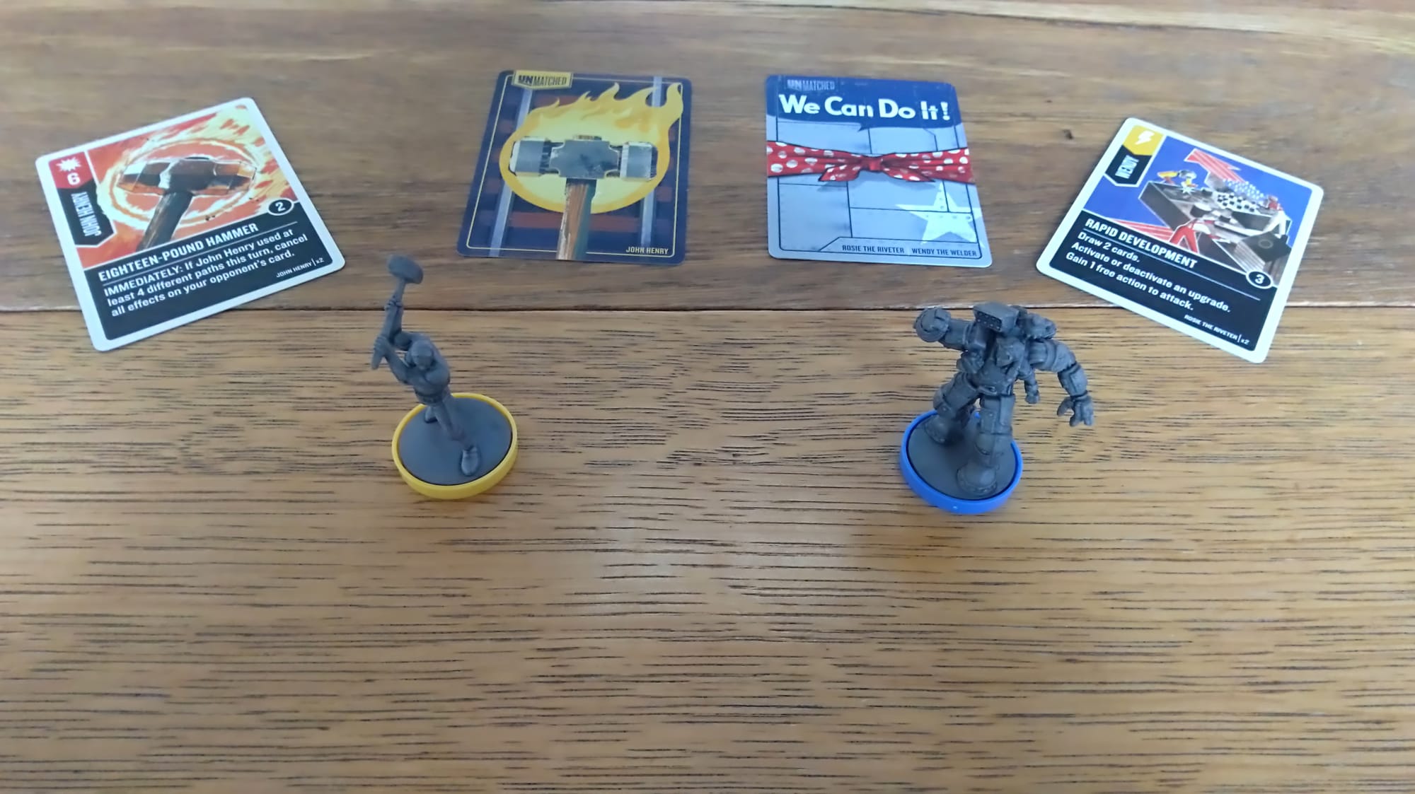 John Henry and Rosie the Riveter's minis in front of a couple of their cards