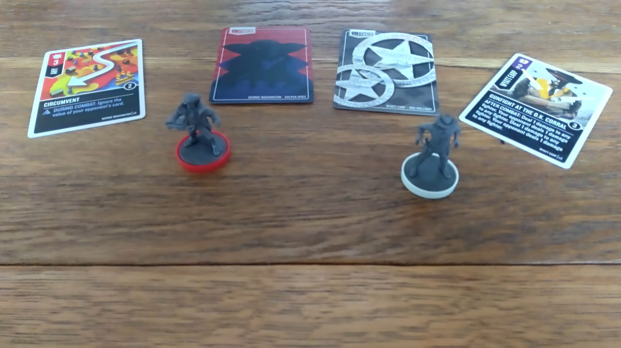 Wyatt Earp and George Washington's hero minis in front of their cards