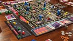 A board showing a city grid with police, snitches, kingpins, and goons all trying to vie for territory.