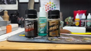 A photo of the AK Interactive Bronze effects and AK Interactive Rust effects on a work table