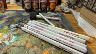 A photo of army painter paint brushes on a painting table
