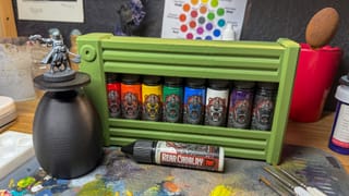 A photo of The 8 Paint Color Cartridge, Happy Oni Plinth handle, and a Victoria Miniatures model