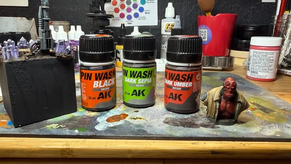 A photo of AK Interactive Pin Washes and 2 models